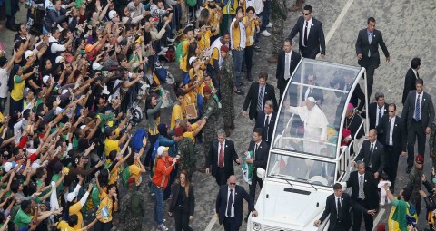 People wave to Pope Francis as he arrives for World Youth Day closing Mass