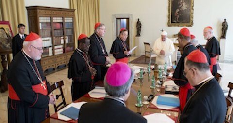 Pope Francis prays during meeting with cardinals at Vatican