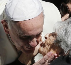Pope accepts kiss from elderly woman during general audience in St. Peter's Square at Vatican