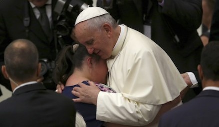 Pope Francis embraces woman during weekly audience at Vatican