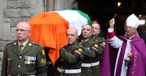 Coffin of former Irish Prime Minister Albert Reynolds is carried out of church following funeral Mass