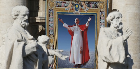 Tapestry of Blessed Paul VI hangs from facade of St. Peter's Basilica during his beatification Mass at Vatican