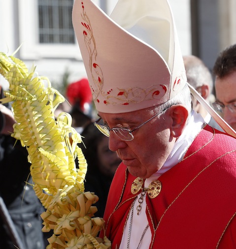 Pope Francis carries palm fronds in procession at start of Palm Sunday Mass in St. Peter's Square at Vatican