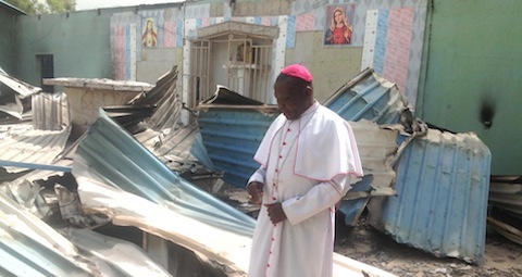 7 0511Nigeria_Bishop Oliver Dashe Doeme in the remains of a Catholic church in Bahuli, Maiduguri diocese targeted by Boko Haram (image courtesy of Maiduguri diocese)