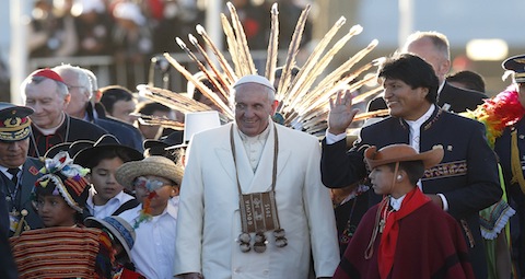 Pope Francis walks with Bolivian President Evo Morales and a children in traditional dress as he arrives at El Alto International Airport in La Paz, Bolivia, July 8. The airport is at 13,325 feet above sea level. (CNS photo/Paul Haring)