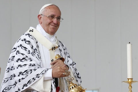 Pope Francis smiles at someone while using incense during Mass in Bicentennial Park in Quito, Ecuador, July 7. (CNS photo/Paul Haring) See POPE-UNITY July 7, 2015.