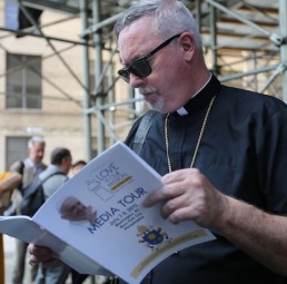 Bishop Christopher J. Coyne of Burlington, Vt., looks at a program during a July 9 media tour in Philadelphia for Pope Francis' trip to the U.S. in September. (CNS photo/Bob Roller)