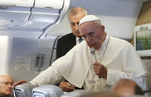 Pope Francis answers questions from journalists aboard his flight from Bangui, Central African Republic, to Rome Nov. 30. (CNS photo/Paul Haring) See story to come.