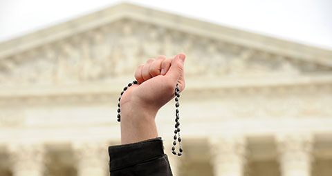 A pro-life advocate holds up a rosary outside the U.S. Supreme Court Jan. 27 during the annual March for Life in Washington. (CNS photo/Leslie E. Kossoff) See LIFE-MARCH-PARTICIPANTS Jan. 27, 2017.