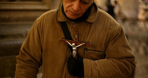 A man holds a crucifix at the cathedral in Santiago, Chile, May 18, 2018. The Archdiocese of Santiago has recommended the former rector of the cathedral be removed from the clerical state after allegations of abuse and his remarks about the church. (CNS photo/Ivan Alvarado, Reuters) See SANTIAGO-CATHEDRAL-ABUSE March 15, 2019.