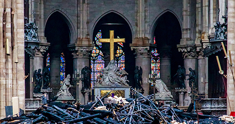 Debris surrounds a depiction of the Pieta by Nicolas Coustou in Notre Dame Cathedral April 16, 2019, a day after a fire destroyed much of the church's wooden structure. Officials were investigating the cause of the blaze, but suspected it was linked to renovation work that started in January.