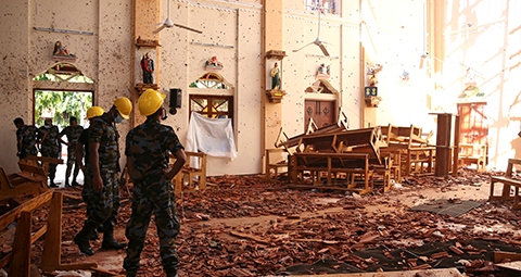 Officials look over the damaged  St. Sebastian Catholic Church April 22, 2019, following a bomb blast in Negombo, Sri Lanka. (CNS photo/Athit Perawongmetha, Reuters) See SRI-LANKA-EASTER-BOMBINGS, DINARDO-SRI-LANKA-ATTACKS, and EASTER-SEASON-ATTACKS April 23, 2019.