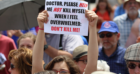 A woman holds up a sign during a rally against assisted suicide in 2016 on Parliament Hill in Ottawa, Ontario. In a Toronto speech, Cardinal Gerhard Muller, prefect of the Congregation for the Doctrine of the Faith, has urged Canadians to work to reverse euthanasia rulings. (CNS photo/Art Babych) See CANADA-MULLER-EUTHANASIA May 17, 2017.